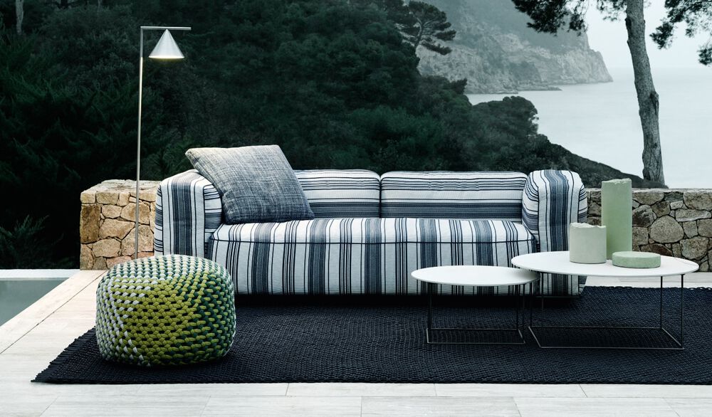 Inviting Outdoor Setting by B&B Italia: Featuring a Cozy Hybrid Sofa, Stylish Armchair and fat-fat Small Table in a Modern Arrangement.
