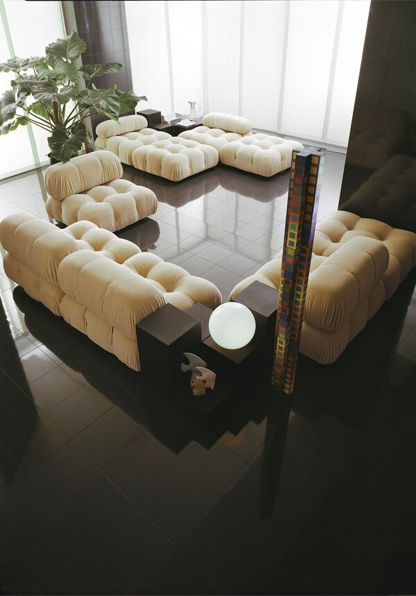 Camaleonda white valvet sofa in a black setting